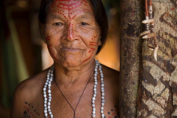 Anciã indígena com adornos tradicionais e pintura facial em Manus.