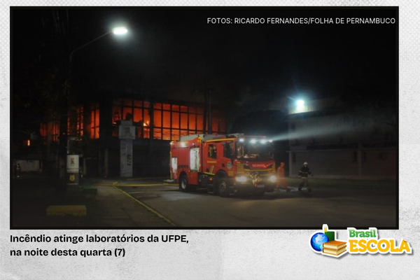Foto de viatura dos bombeiros na frente do prédio da UFPE em chamas.