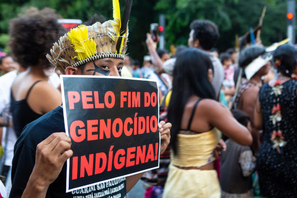 Indígena em manifestação contra o genocídio indígena